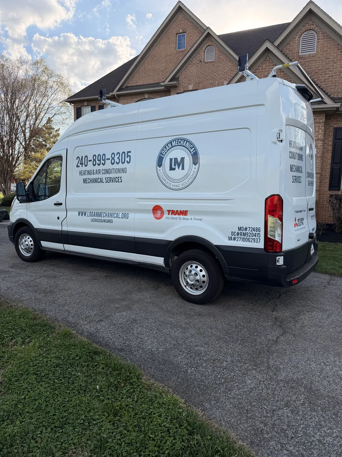 Logan Mechanical service van at a DMV-area home
